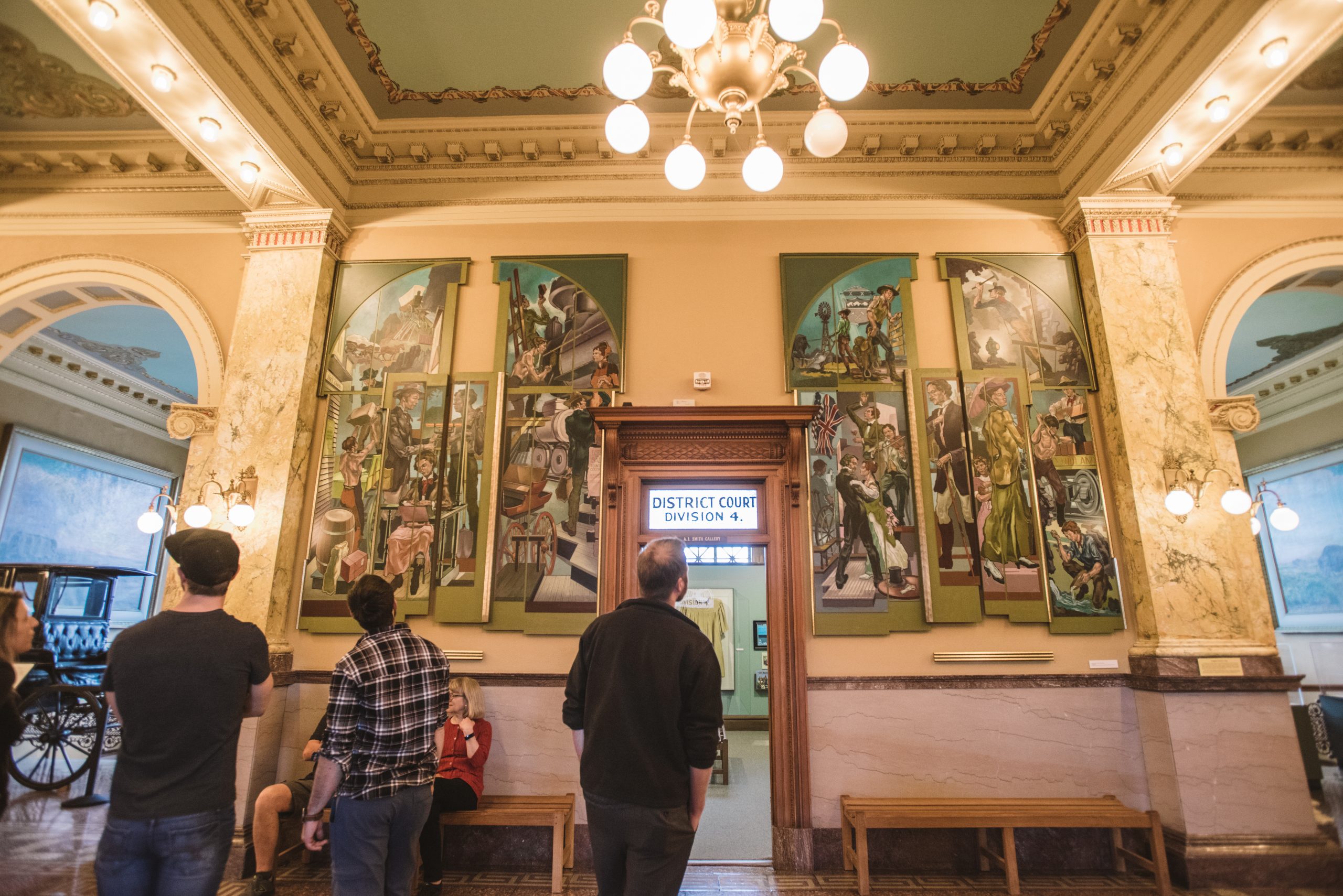 People look at murals in the Colorado Springs Pioneers Museum
