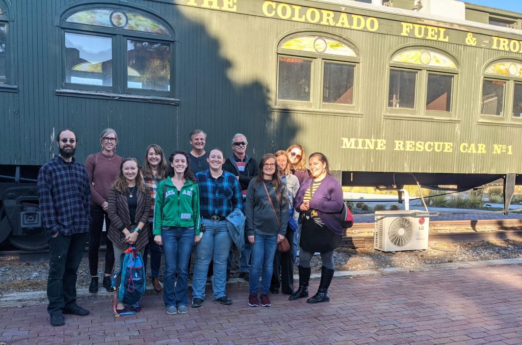 Group of people in front of train car