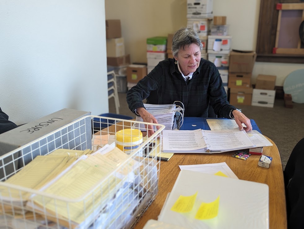 Kitty West, Admin Volunteer, sorting through files.