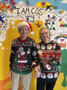 Kathy Lindeman and her husband in front of the IAMCOS Mural at the CSPM Annex.