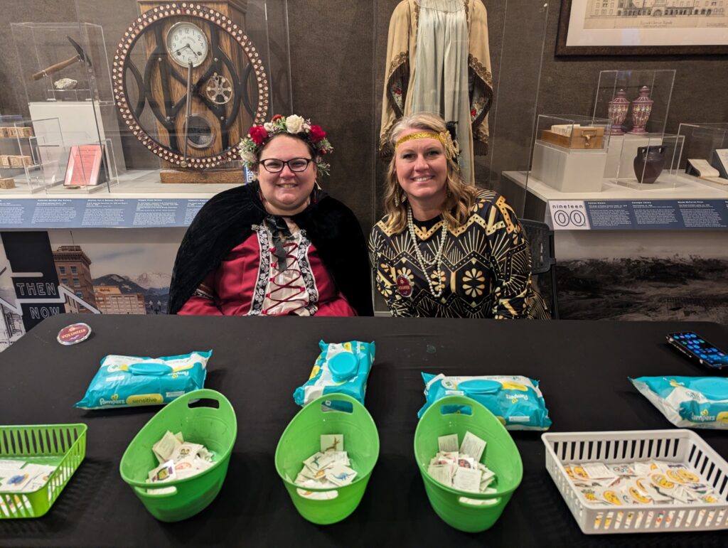 Kassandra Merryfield and a volunteer from Colorado Springs Utilities leading an activity at the Night at the Museum event.