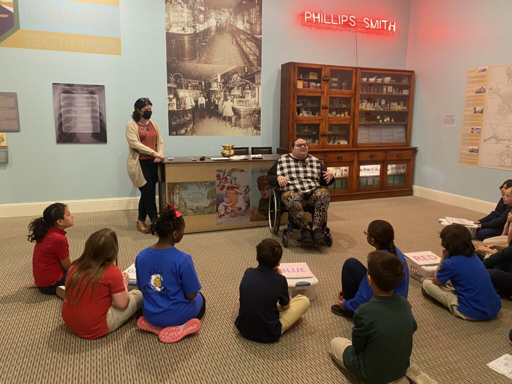 Kassandra Merryfield presenting at the City of Sunshine exhibit to a group of elementary students.