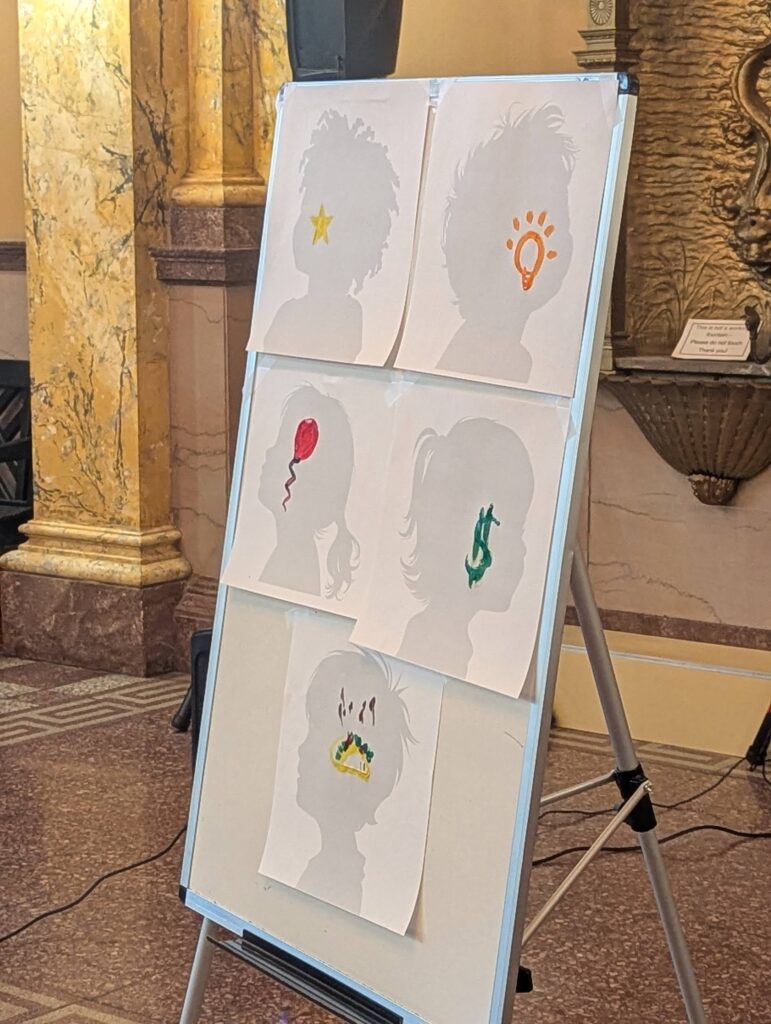 A board shows five face painting designs.