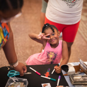 Child creating art at the CSPM's Grand Reopening Family Fun Day, Colorado Springs Pioneers Museum.
