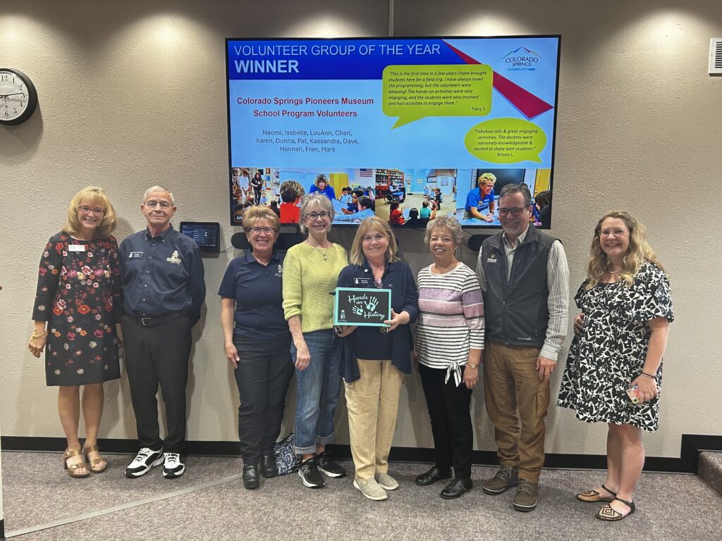 School program volunteers pose with their volunteer team of the year award.