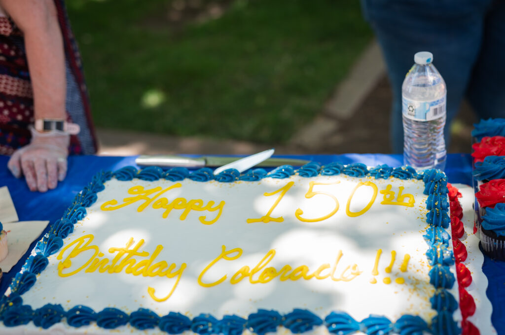 A Birthday Cake with Happy 150th Birthday Colorado Written on It.