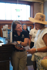 CSPM Volunteer Tanja Britton speaking with a visitor during Colorado Day.