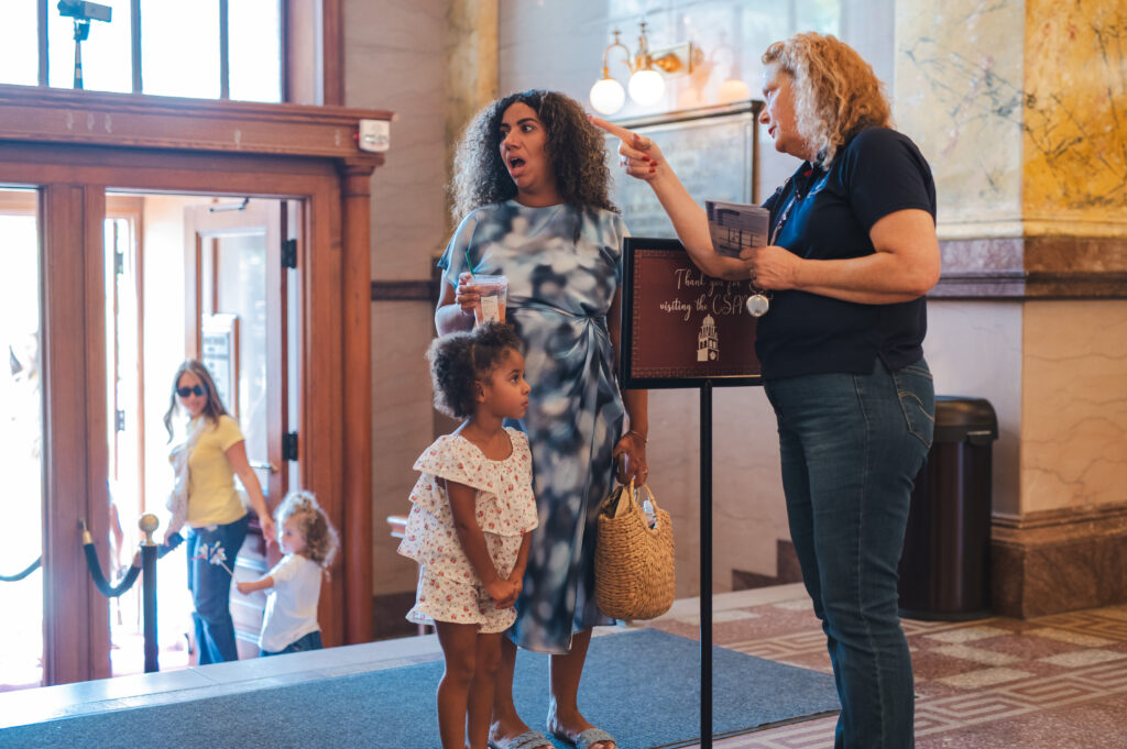 CSPM Volunteer greeting guests during Colorado Day 2026.
