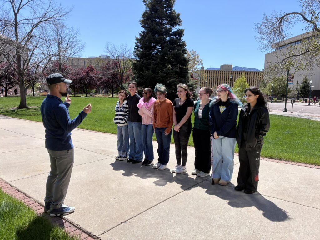 Junior Docents stand in a line outside for a group activity.