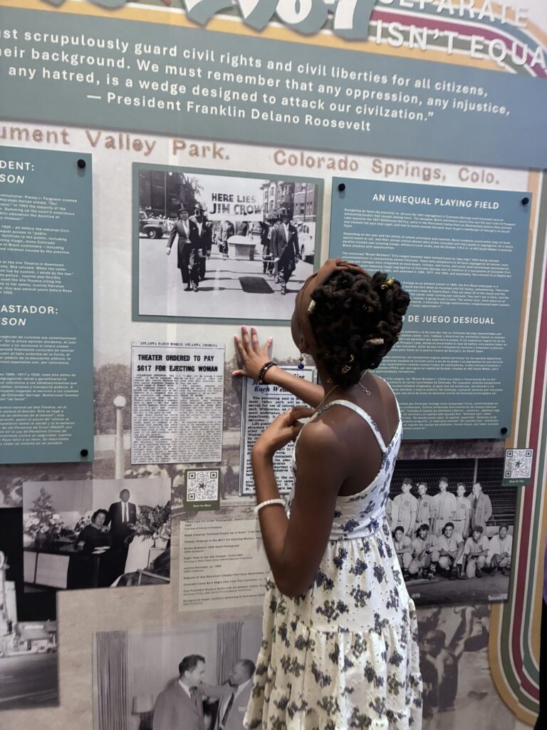Visitor reading in the "Freedom to Thrive" exhibit.