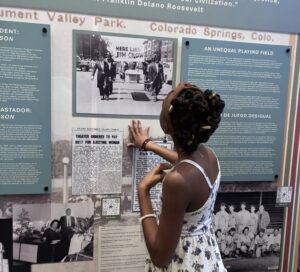 Visitor reading in the "Freedom to Thrive" exhibit.