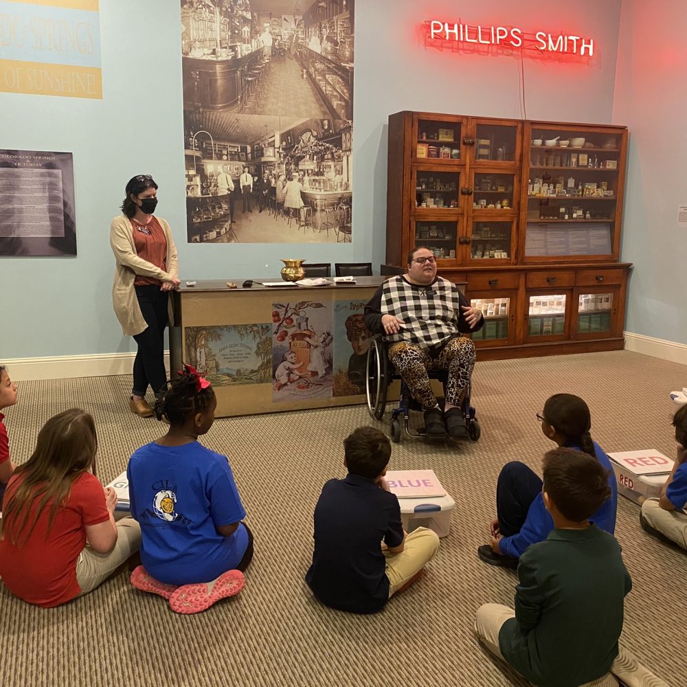 Kassandra Merryfield presenting at the City of Sunshine exhibit to a group of elementary students.